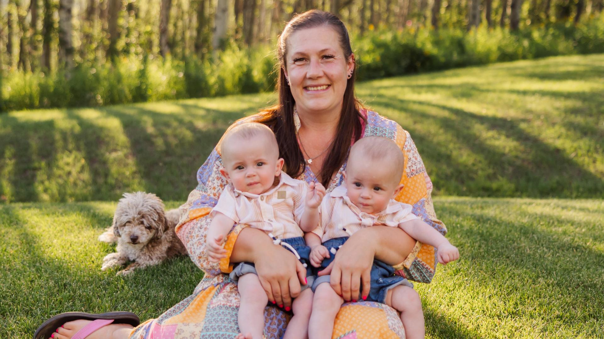Janice poses on the grass for a family photo.