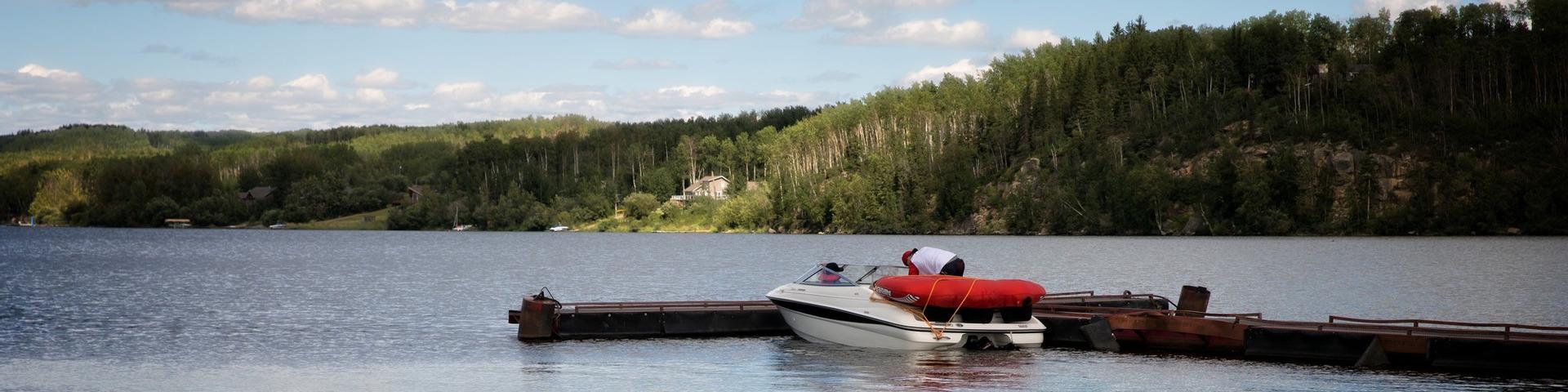 A person prepares a boat on Charlie Lake.