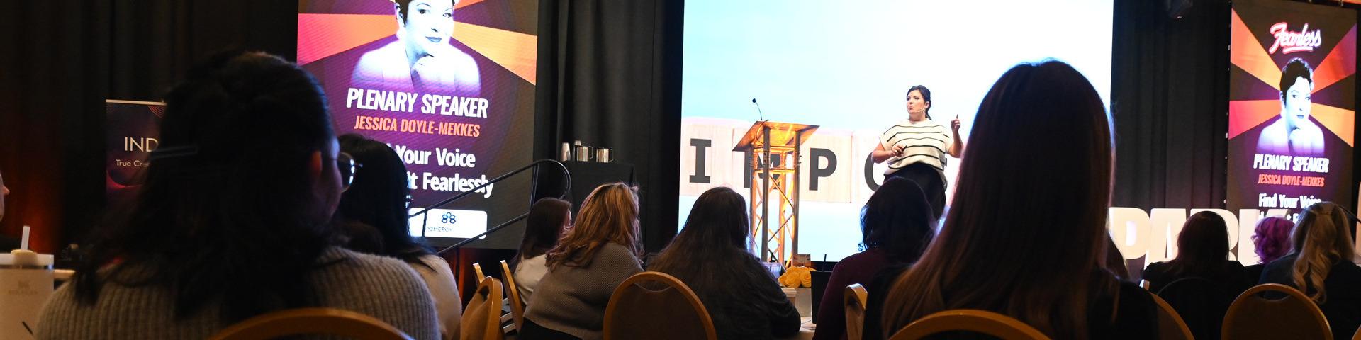 A speaker presents to the group at the SPARK Women's Leadership Conference.